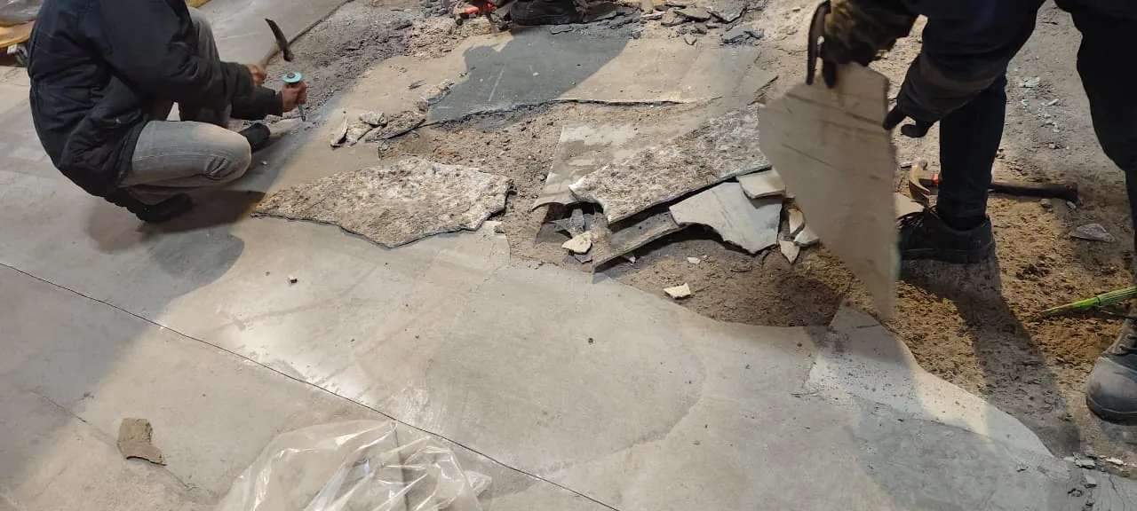 Failed cold storage floor layers being removed to expose the repair area